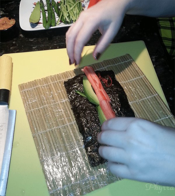 Adding the stuffing to Sushi