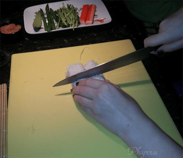 Cutting the sushi in half