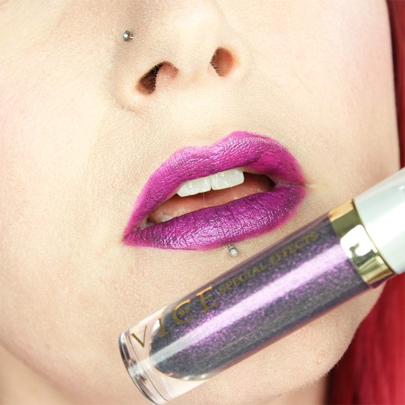 Urban Decay Vice Special Effects Lipstick Topcoat in Reverb on top of Crank Vice lipstick