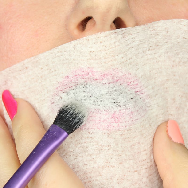 You may already know my favorite lipstick hack. After you've applied your lipstick and blotted it, take a tissue and hold it over your lips, then use a brush to sweep setting powder over your lips. This will help your lipstick last longer.
