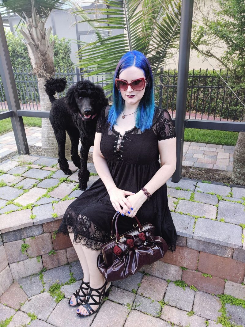 Courtney is wearing her Killstar Bella Morte Lost Babydoll Dress, holding a Valentino Lacca Fleur handbag in burgundy and Naturalizer Danya Sandals. Her standard poodle puppy Nyx. #plussizefashion #witchystyle #gothicfashion #killstar #LTKCurves