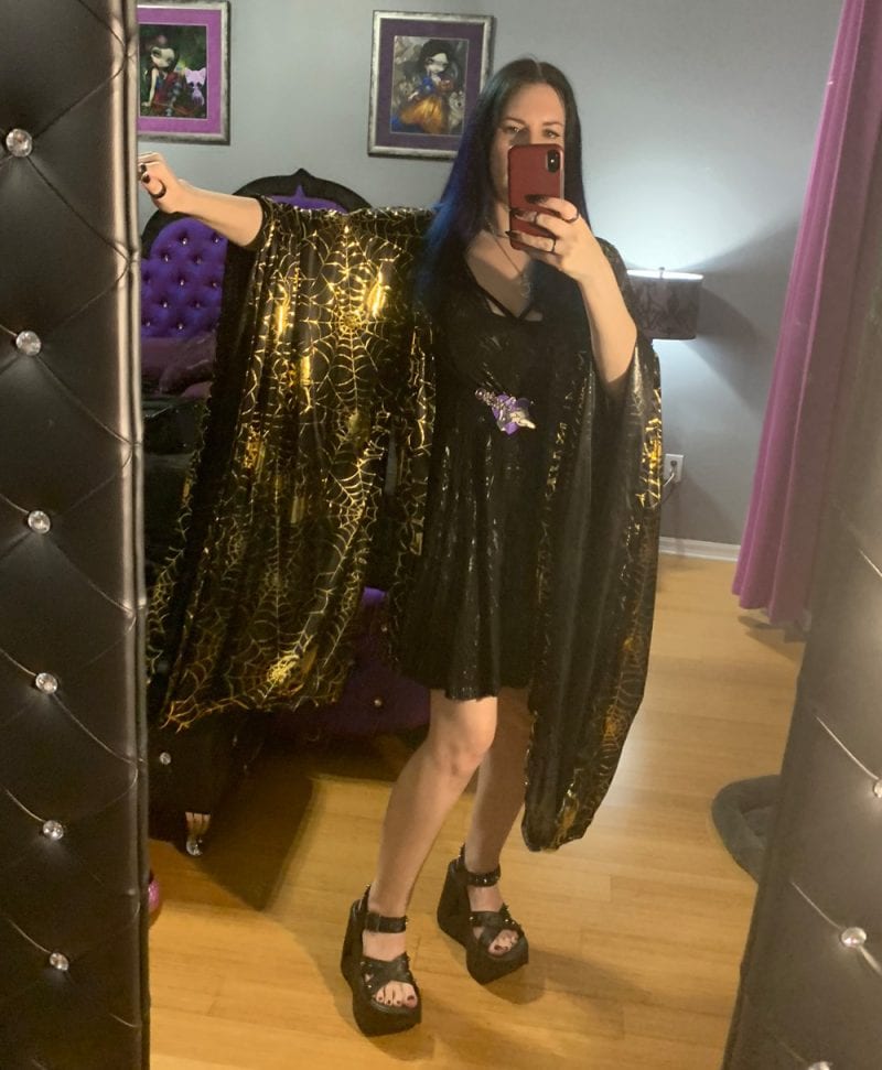 Courtney is wearing a Spellbound Stitches Black and Gold Kimono