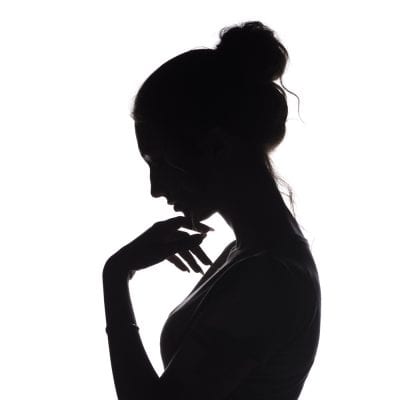 A Woman in Silhouette thinking PMDD is Hell