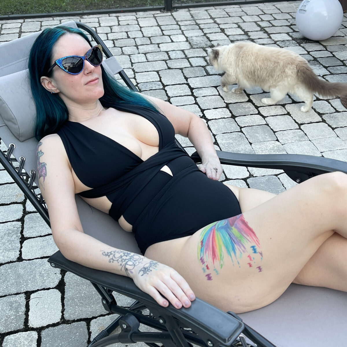 Bad witch by the pool with a cute ragdoll cat in the background
