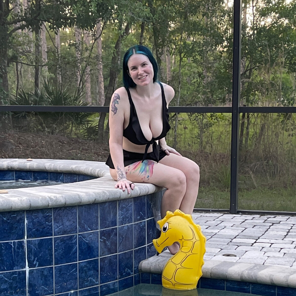 Sitting on the edge of the hot tub in the Circus Bikini