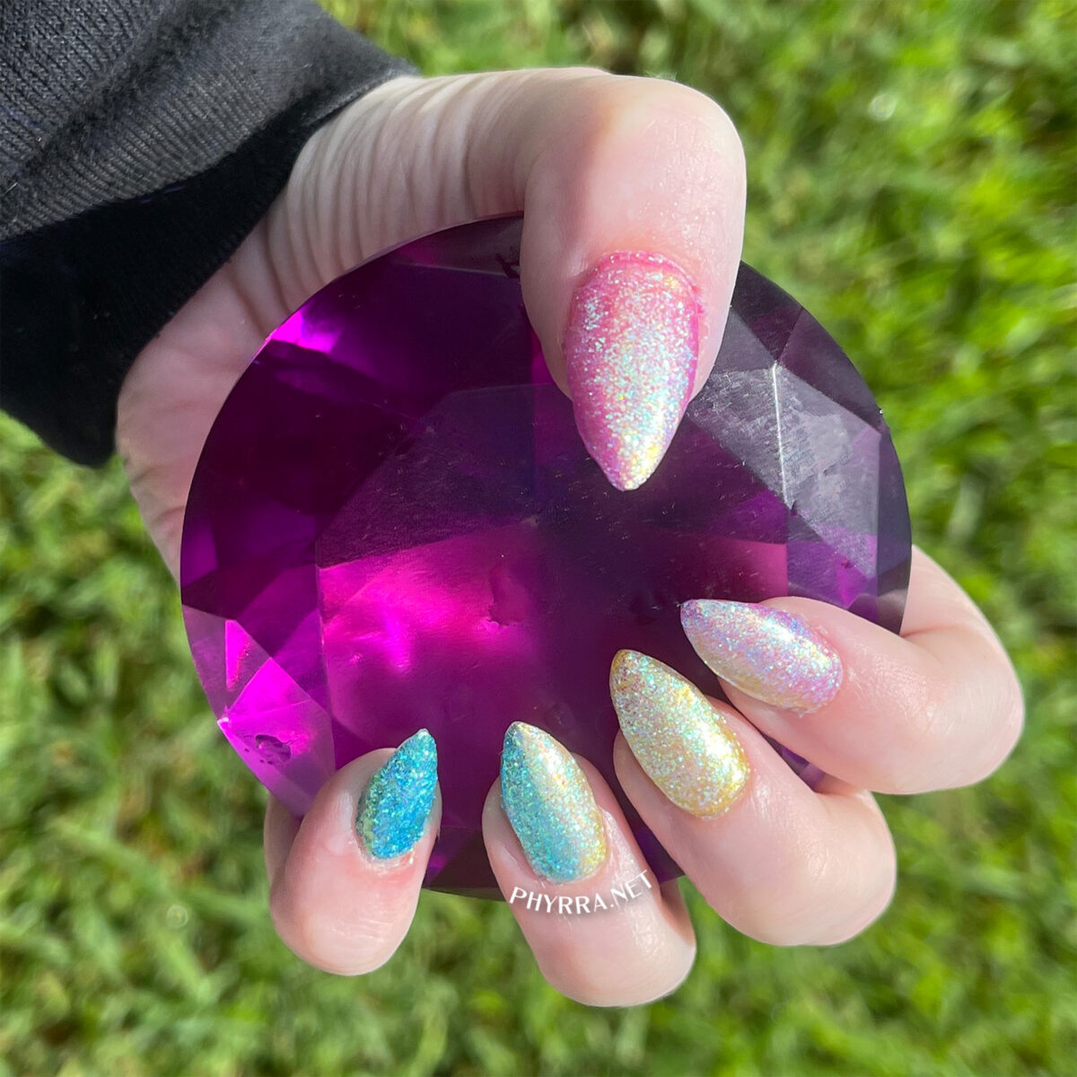 Daily Charme Unichrome powder on pan pride nails holding a purple gem