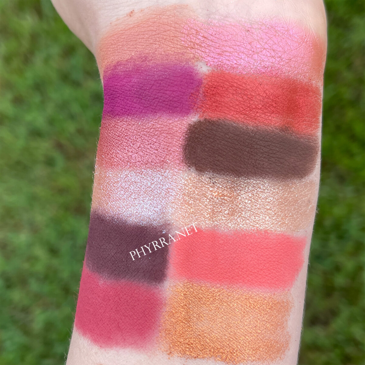 Swatches of the Nabla Wild Berry and Coral Cutie palettes on very fair skin