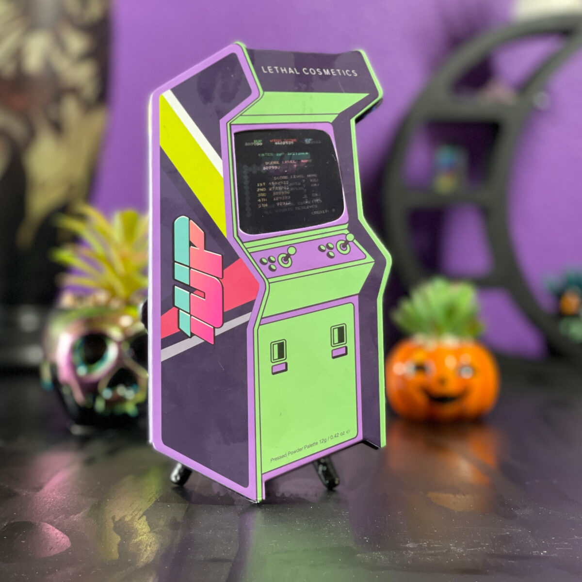 An eyeshadow palette shaped like an 80s Arcade Game Machine
