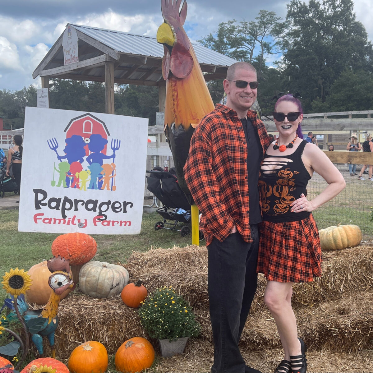 Cordelia and Dave at the Fall Pumpkin Festival wearing Foxblood flannel matching outfits