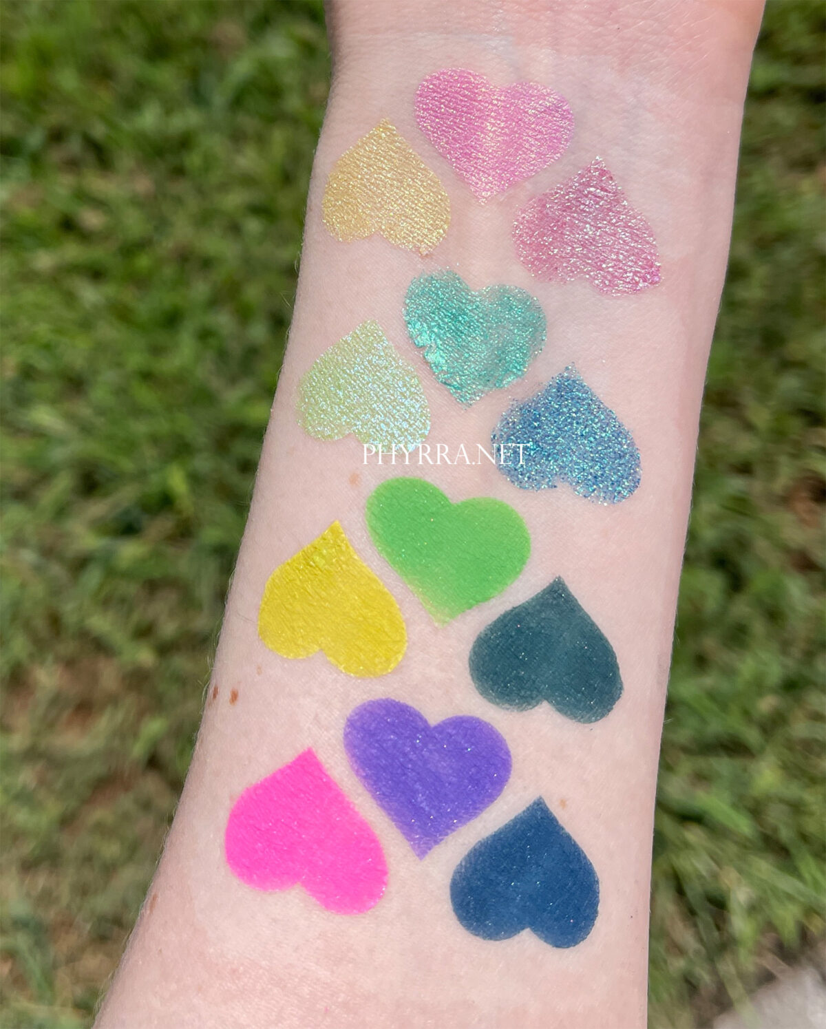 Light skin swatches of the Lethal Cosmetics 1UP palette in direct sunlight