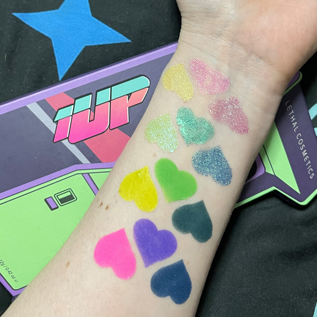 1UP Palette swatches on pale skin in artifical light