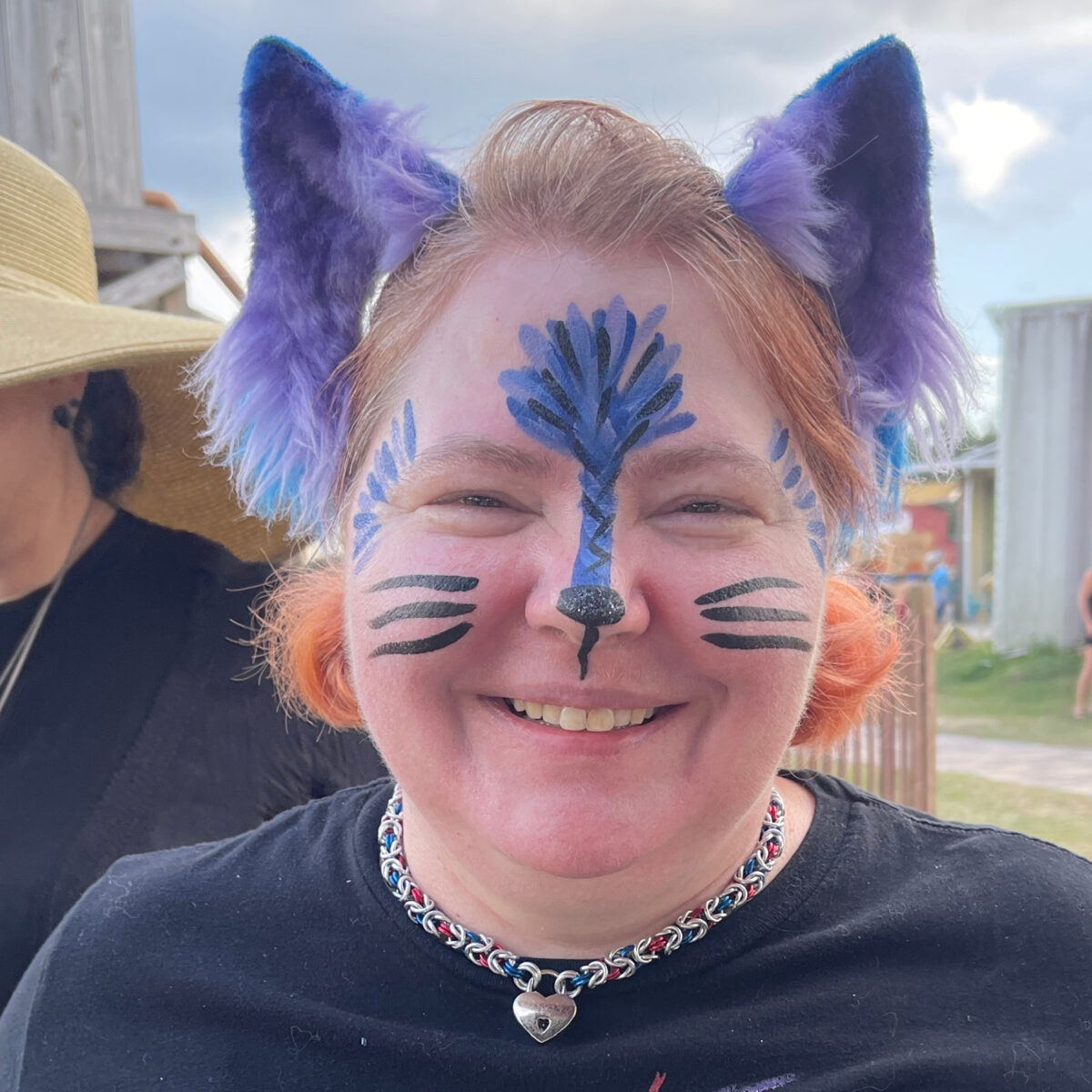 a woman with a painted face at the Fall Pumpkin Festival