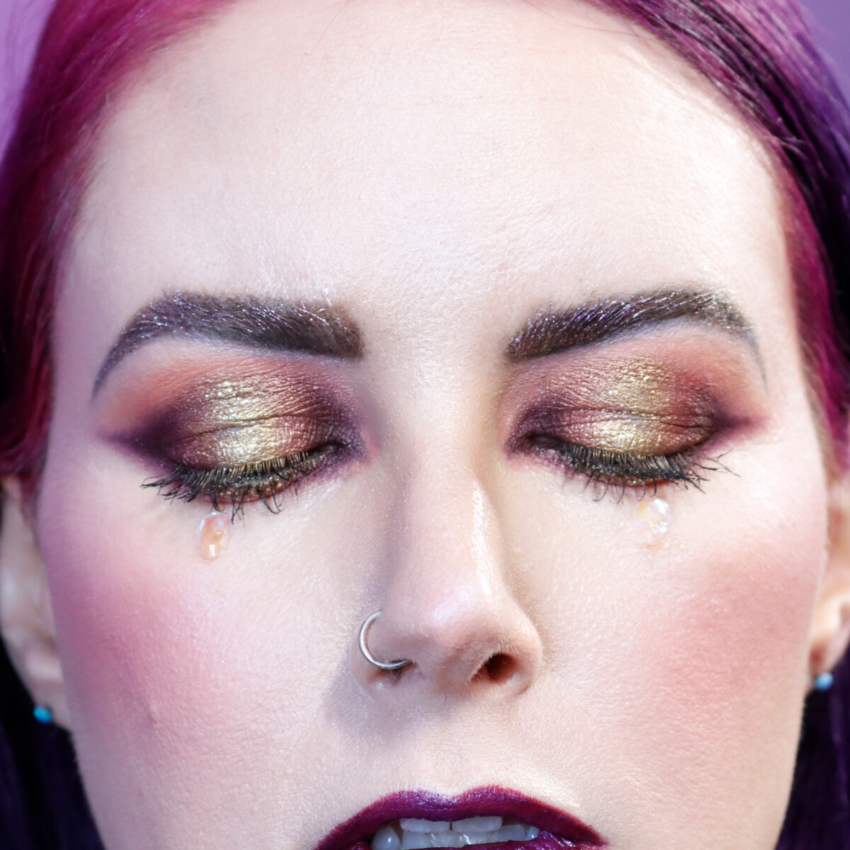 Cordelia is wearing autumn halo eyes makeup on hooded eyes with AB skull accents