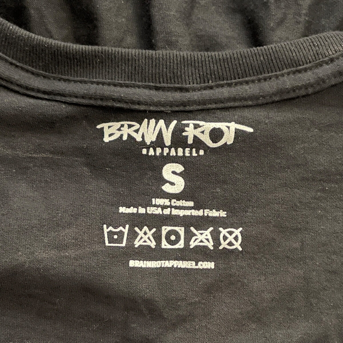 a photo of the printed tag on Brain Rot Apparel t-shirts