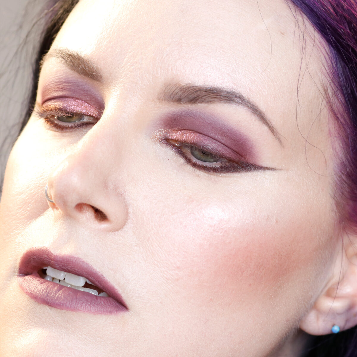 Cordelia is wearing monochromatic purple taupe eyes, cheeks and lips