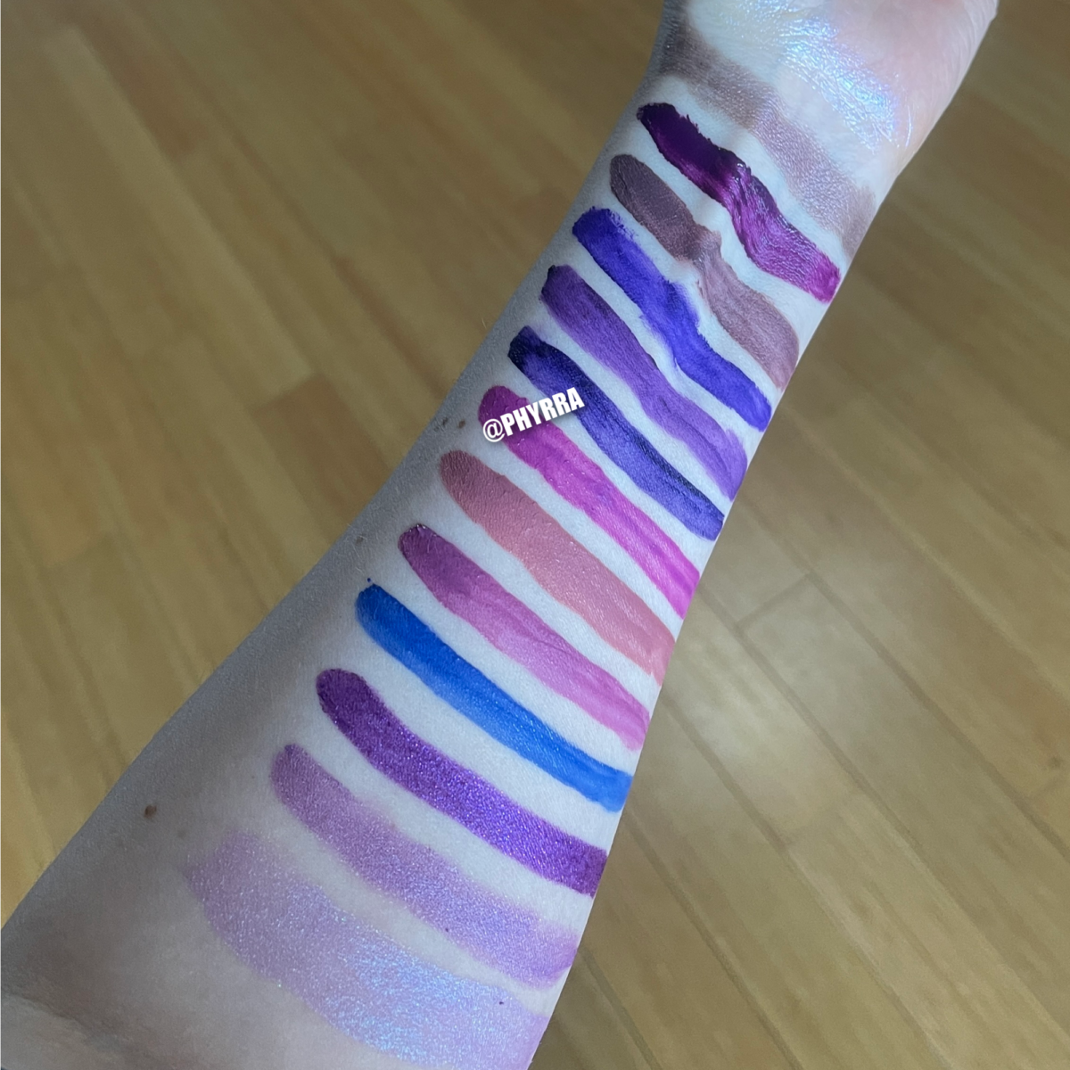 purple lipstick and lipgloss swatches on pale skin
