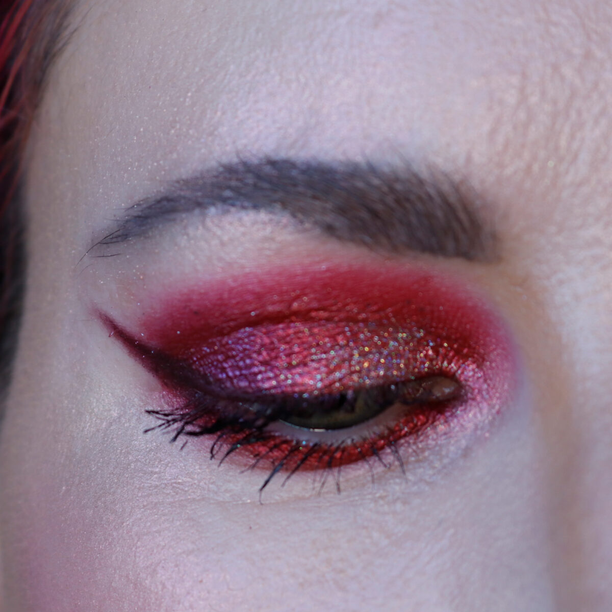 Fun Cosmetics Holo Boss Prisma Eyeshadow on top of red metallic